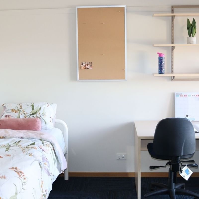 Neat bedroom with desk and bed at La Trobe University Terraces.