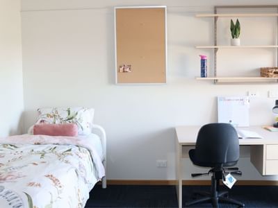 Neat bedroom with desk and bed at La Trobe University Terraces.
