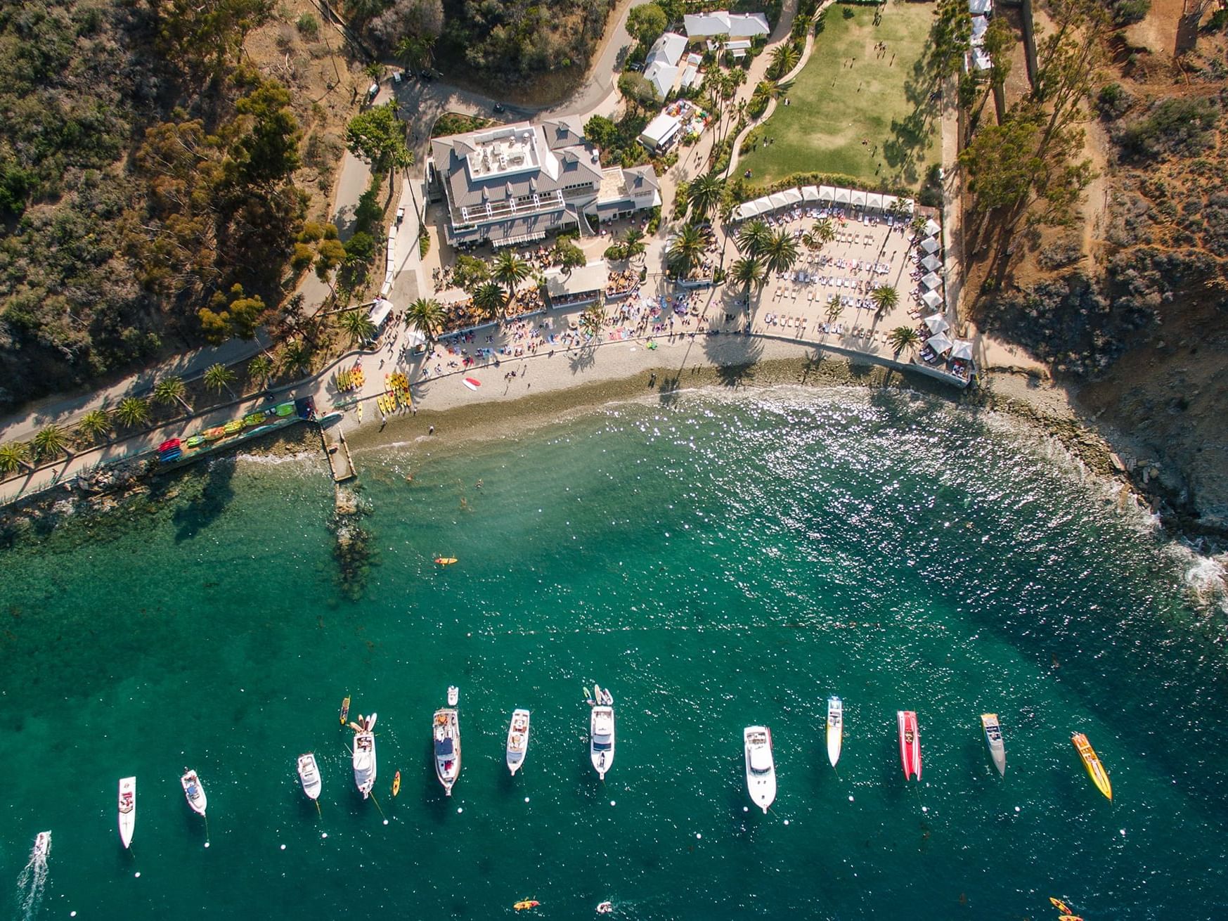 Aerial view of a coastline with boats and beachgoers near Catalina Island Company