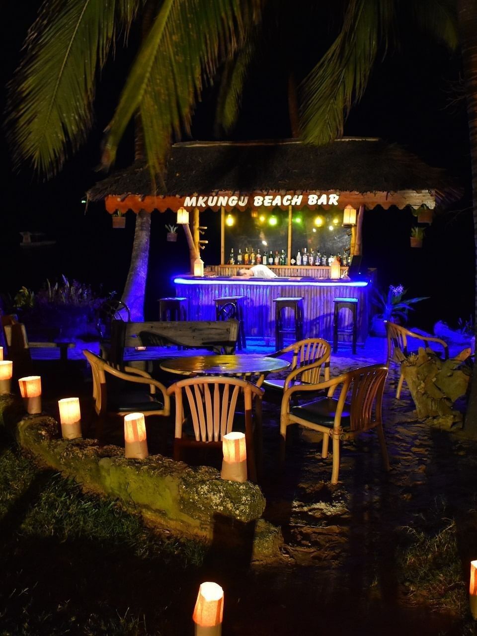 Illuminated Mkungu Beach Bar at night with candles and lights at Serena Beach Resort & Spa in Mombasa.