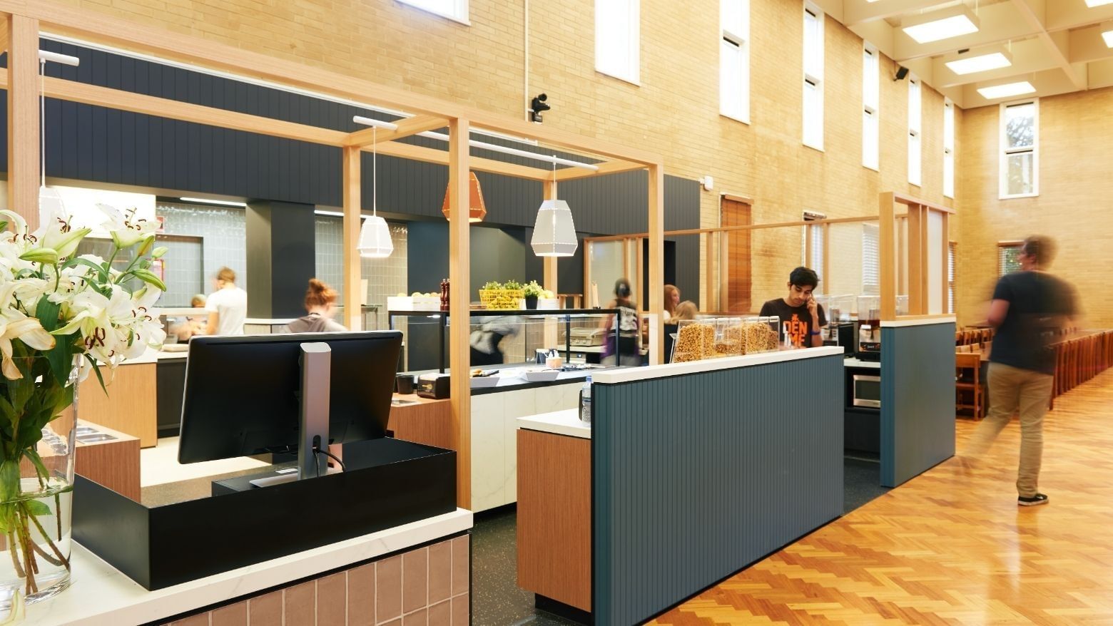 People in the lobby of La Trobe University - Glenn College.