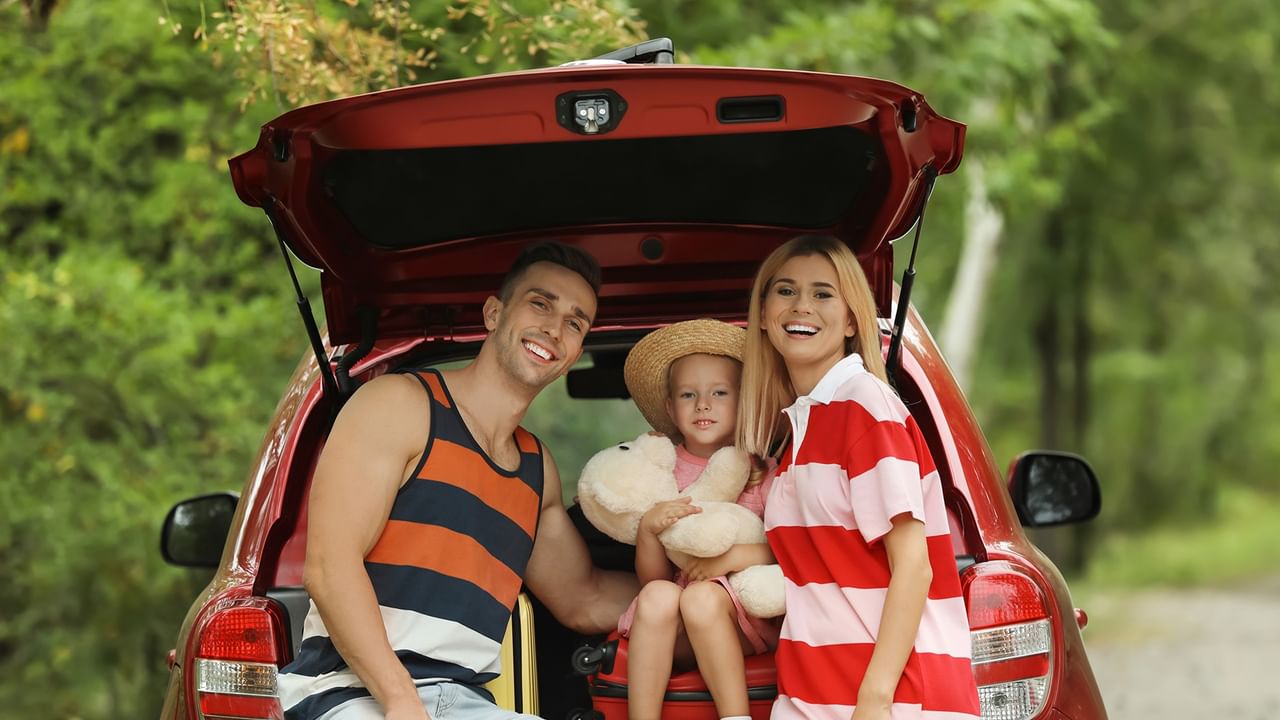 a happy family on a road trip by car