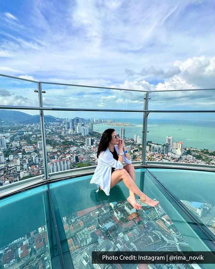 A lady was sitting on the floor at The TOP Penang Rainbow Skywalk - Lexis Suites Penang