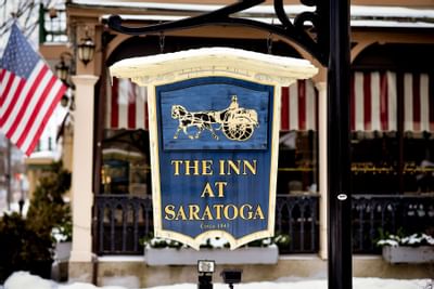 Close-up of the hotel signboard at Inn at Saratoga in Winter