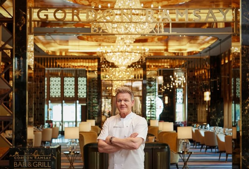 Chef Gordon Ramsay standing confidently inside the Gordon Ramsay Bar & Grill at Sunway Resort
