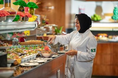 Chef setting up the buffet in the Seasons Restaurant at Bay La Sun Hotel & Marina