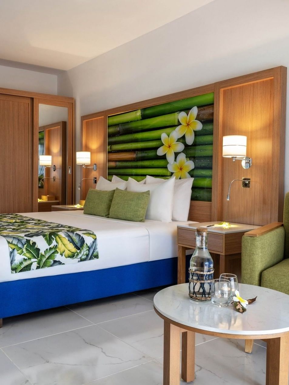 Large bed beside cozy green armchair with tropical decor in Garden View Room at warwick le lagon-vanuatu