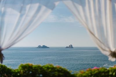 Ocean view through curtains at Cala de Mar