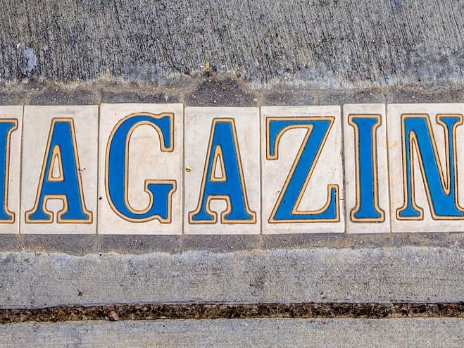 The word MAGAZINE written on a stone wall near La Galerie Hotel