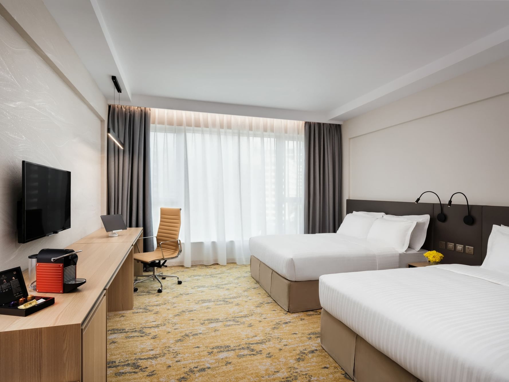 TV & table with coffee amenities facing the bed in Premier Family Quadruple Room at Park Hotel Hong Kong