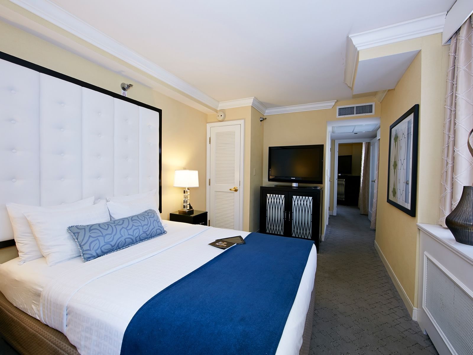 Tufted king bed in Superior Suite at Warwick Allerton