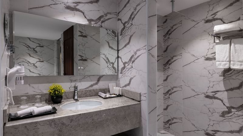 Bathroom vanity area in Junior Suite at Warwick Hotels & Resorts