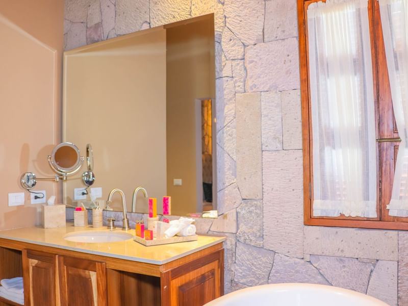 Bathroom vanity area in Deluxe Room at Gamma Hotels