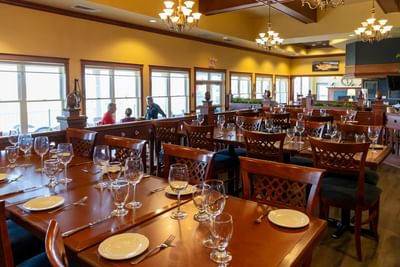 Elegant indoor dining tables setup inside the main Crowbush restaurant at Rodd Crowbush Golf & Beach Resort