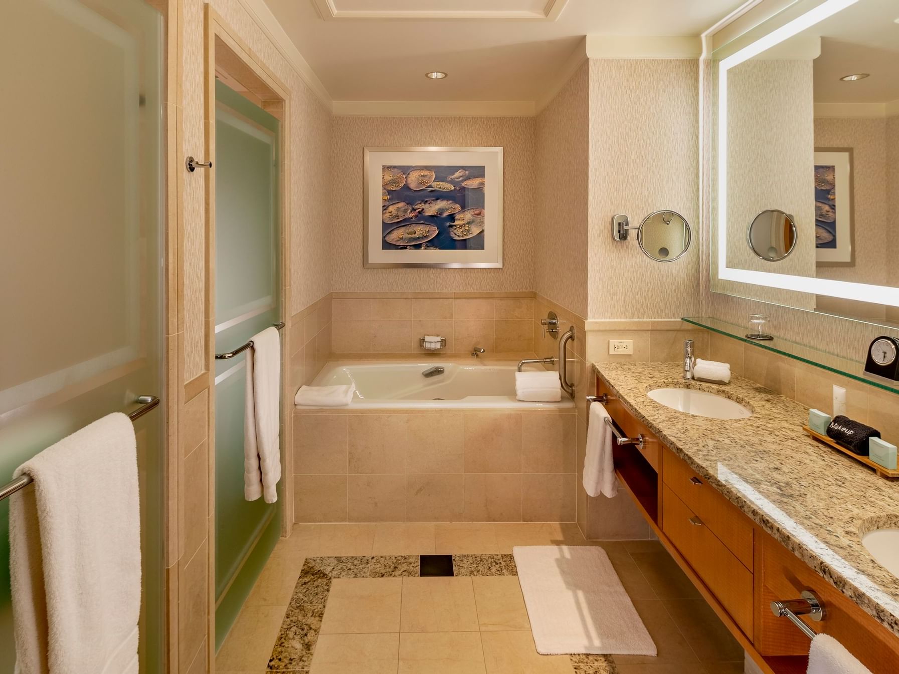 Luxury bathroom bathtub by the vanity in Superior Lake View Balcony King at The Umstead Hotel and Spa
