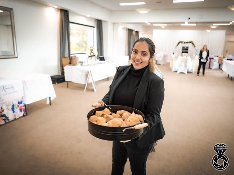 Woman serving pastries in an event at Mercure Gerringong Resort