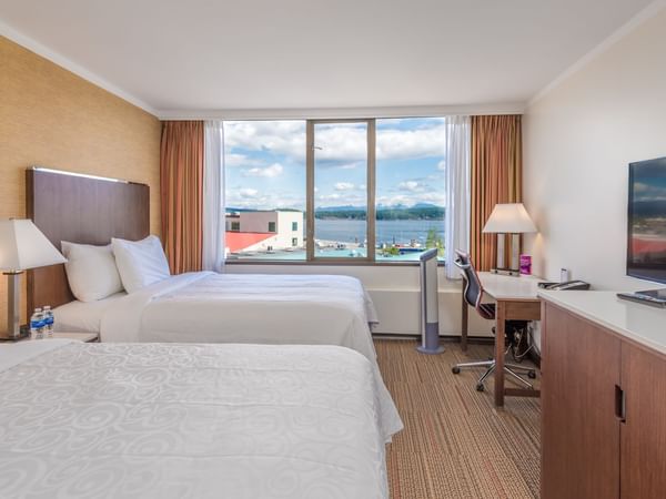Two beds in hotel room with ocean view