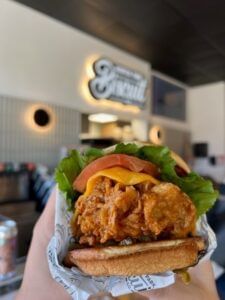 Close-up of a burger holding  at Rosen Inn Universal