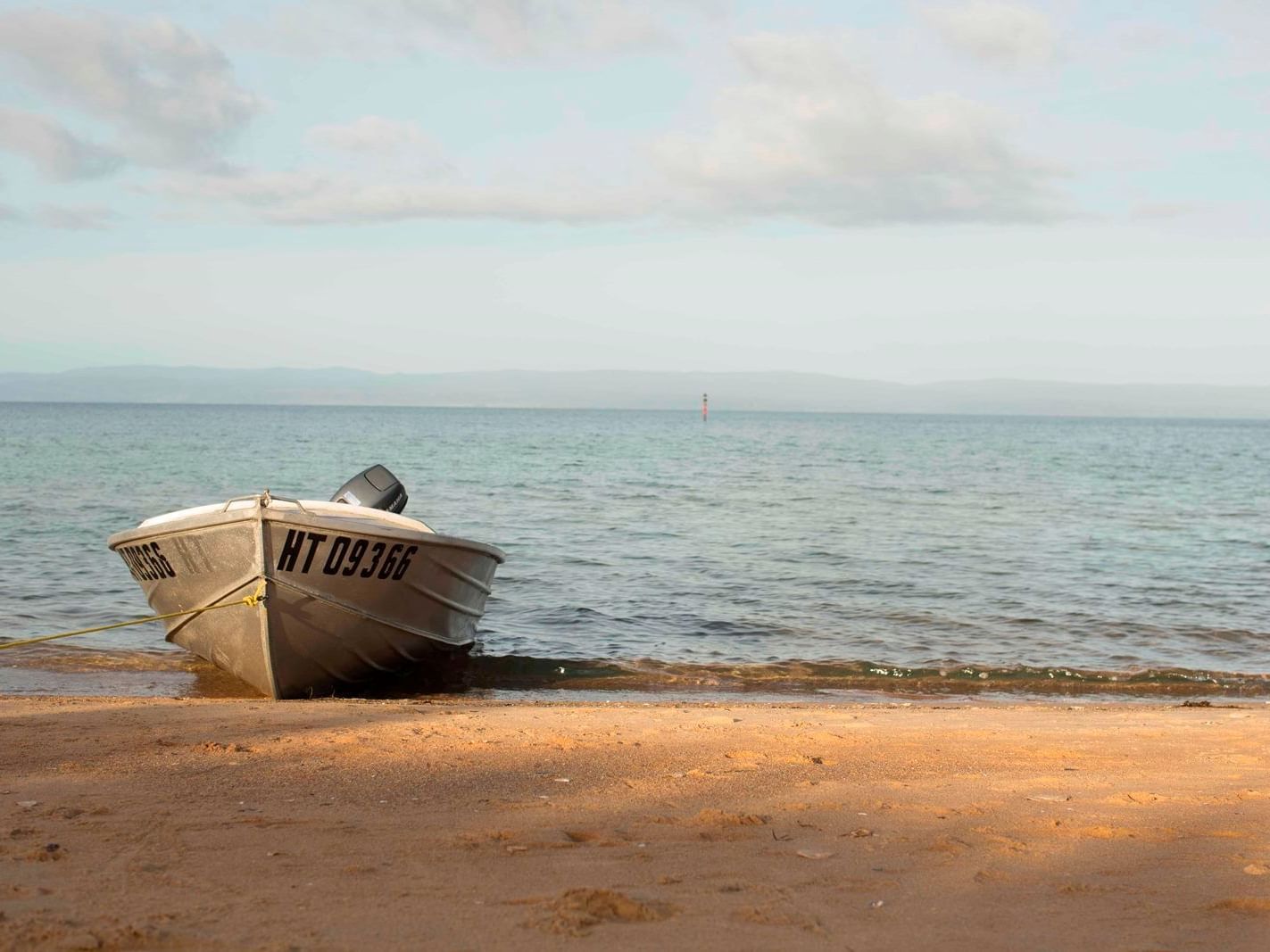 A boat parked on the beach near the Freycinet Lodge
