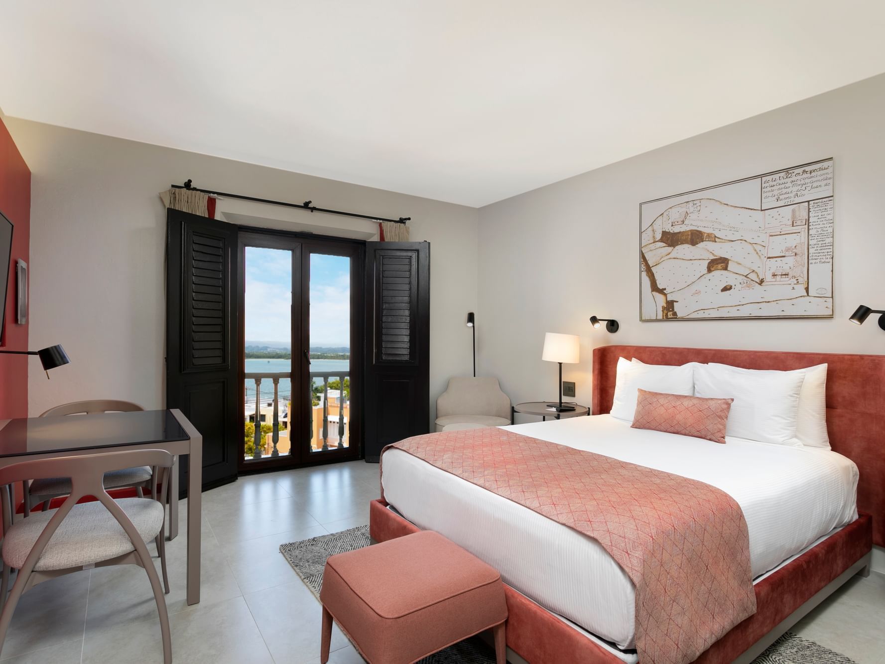 Queen Vista Room picture showing the bed, seating, and window with Old San Juan views