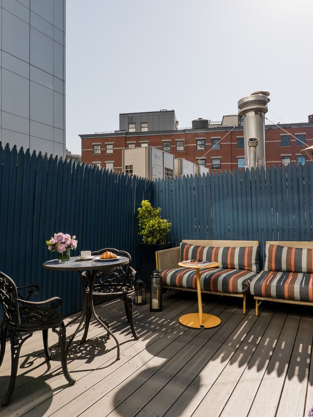 Terrace Room with a sofa, bistro table, and city views from the Gansevoort, one of the perfect hotel rooms in Manhattan