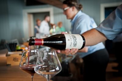 Bartender pouring glass of wine