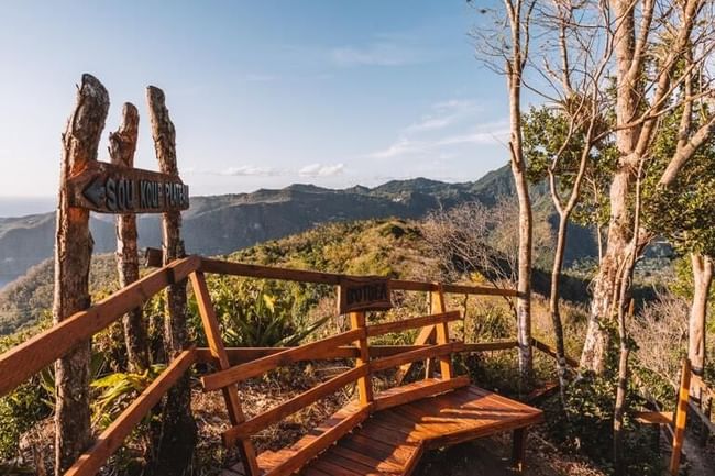 Viewpoint with wooden railing and signs near Ladera Resort one of the St Lucia attractions