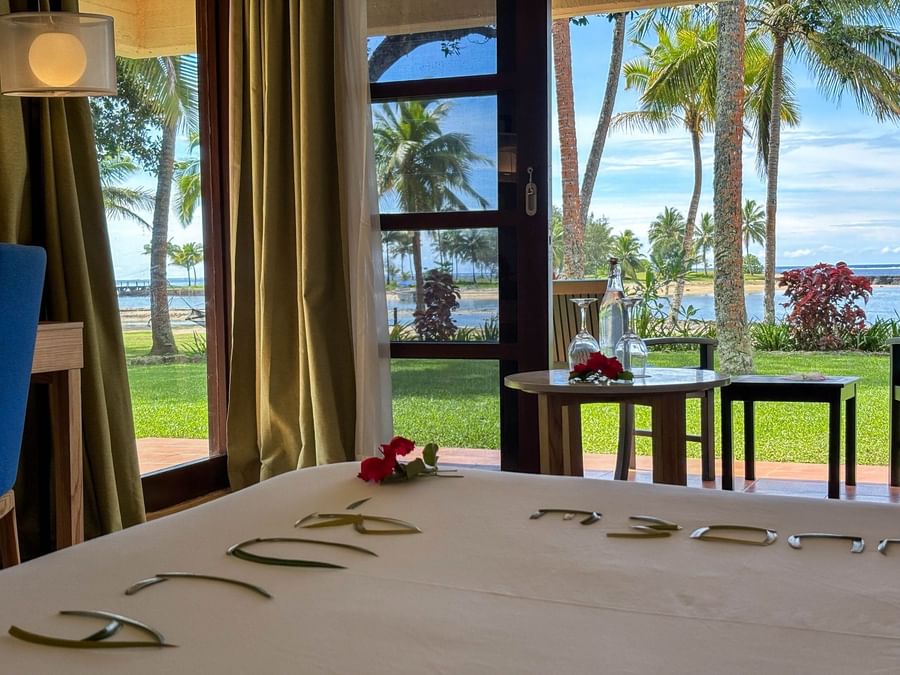 Bedroom view with beach and ocean at The Naviti Resort Fiji.