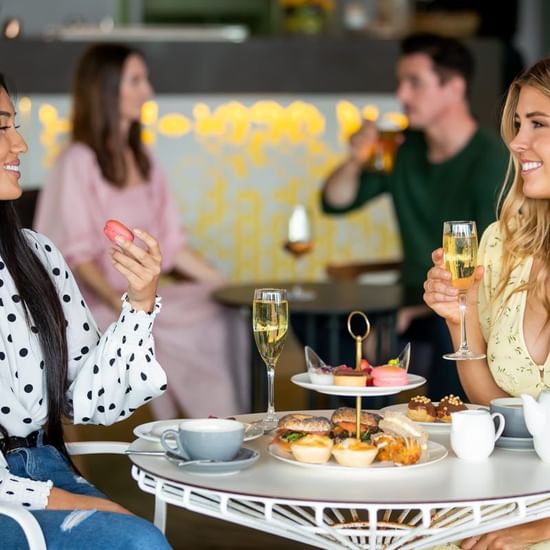 Ladies enjoying a high tea in Shallows Bar at Pullman Magenta Shores