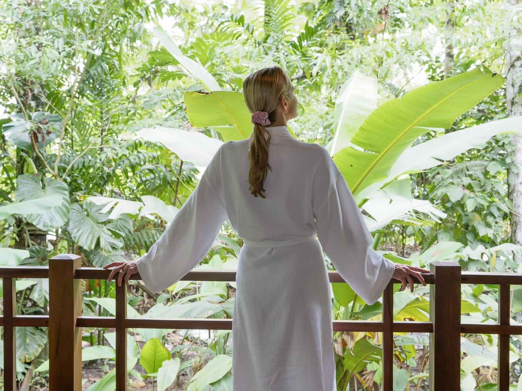 Lady wearing a bathrobe and enjoying nature, Playa Cativo Lodge