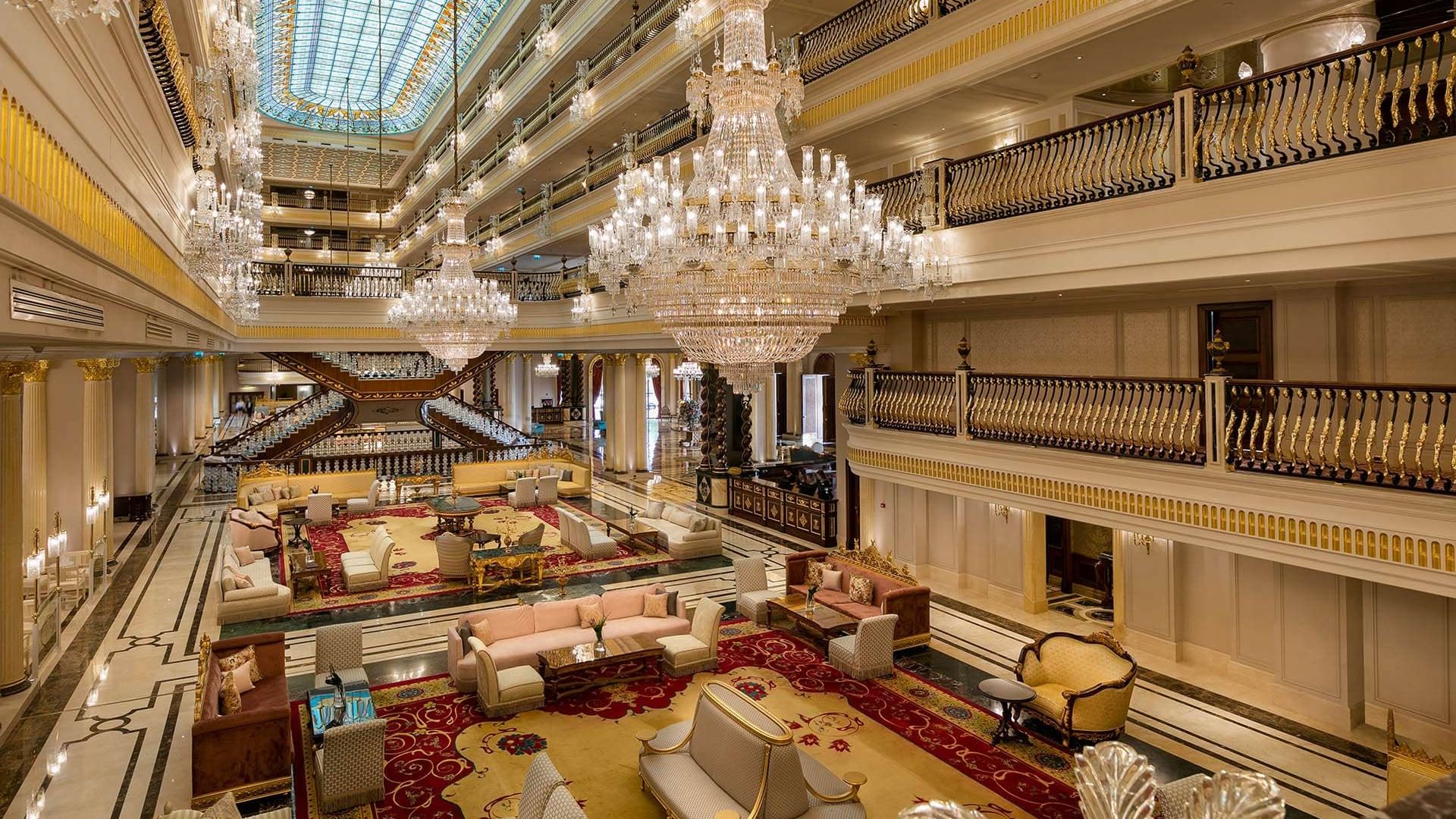 Spacious lobby lounge area with elegant chandeliers at Titanic Mardan Palace