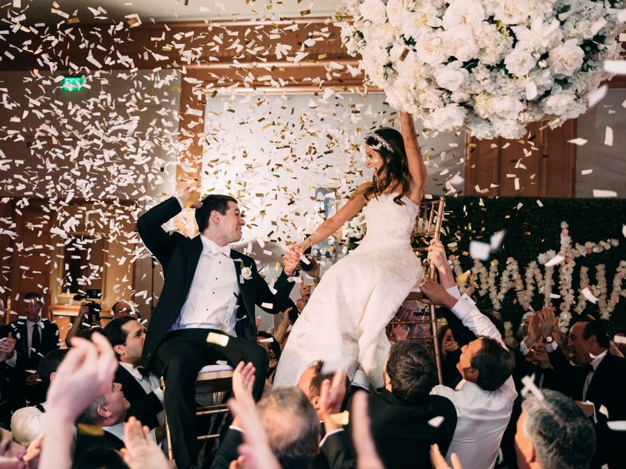 Confetti shower at a wedding couple in Salon at Umstead Hotel and Spa