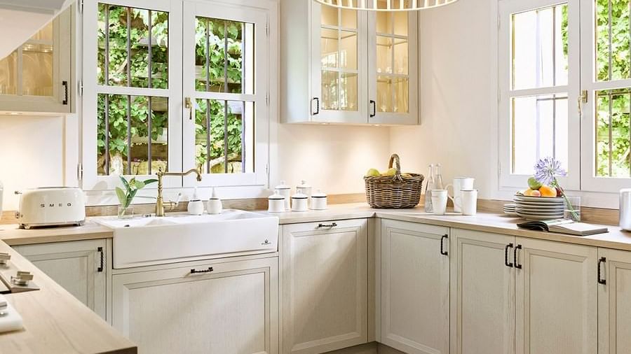 Four-Bedroom Villa kitchen with cabinets, a farmhouse sink, windows, and a woven light fixture at Marbella Club