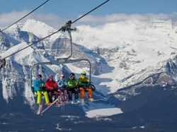 A ski lift carrying a group of skiers in the White Mountains near Acclaim Hotel Calgary