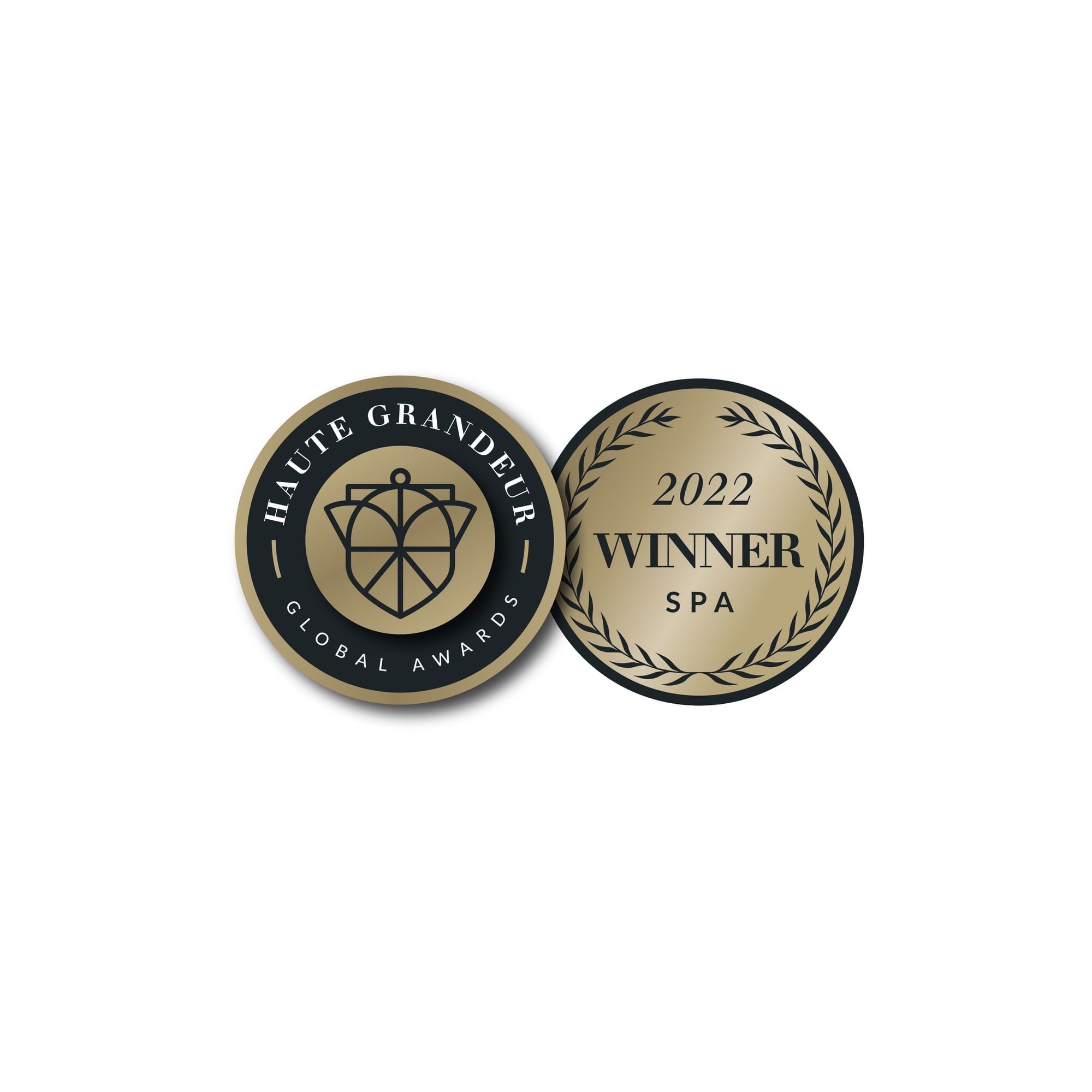 Two badges, one reading Haute Grandeur Global Awards and the other 2022 Winner Spa at Paradox Vancouver