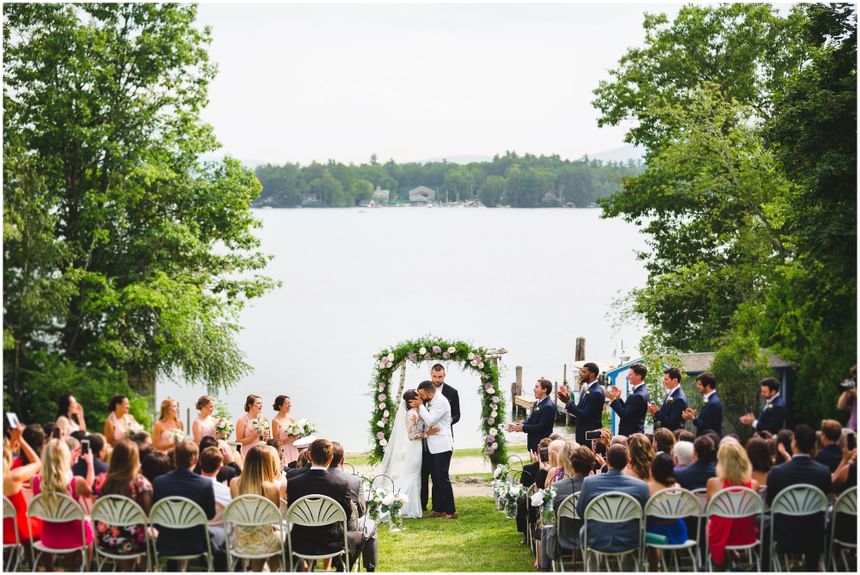 Young couple kissing at wedding reception at Wolfeboro Inn