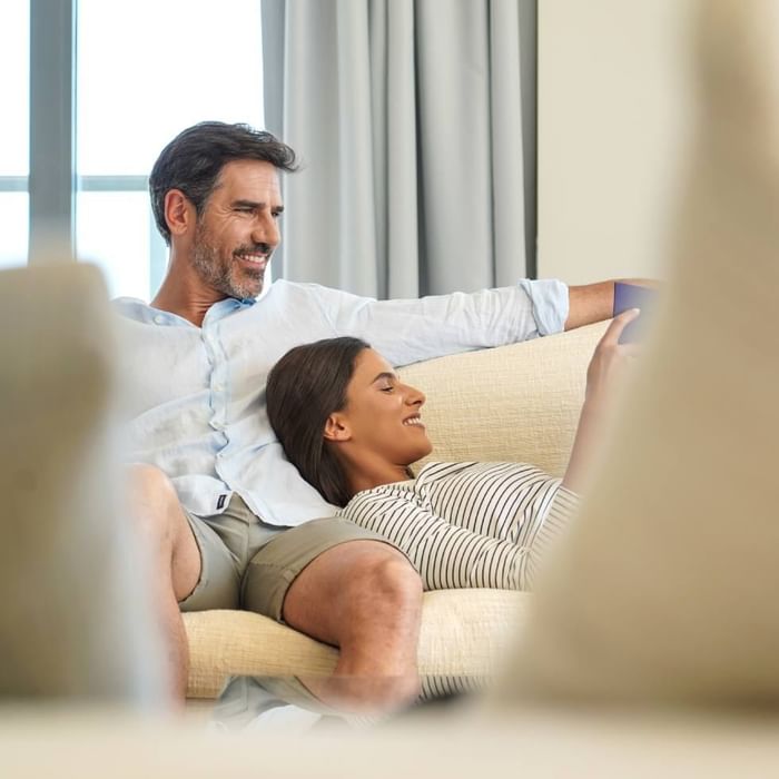 Couple relaxing on a couch at Falkensteiner Hotel Montafon