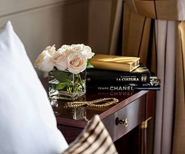 Roses & books on a nightstand at Hotel Emperador Buenos Aires