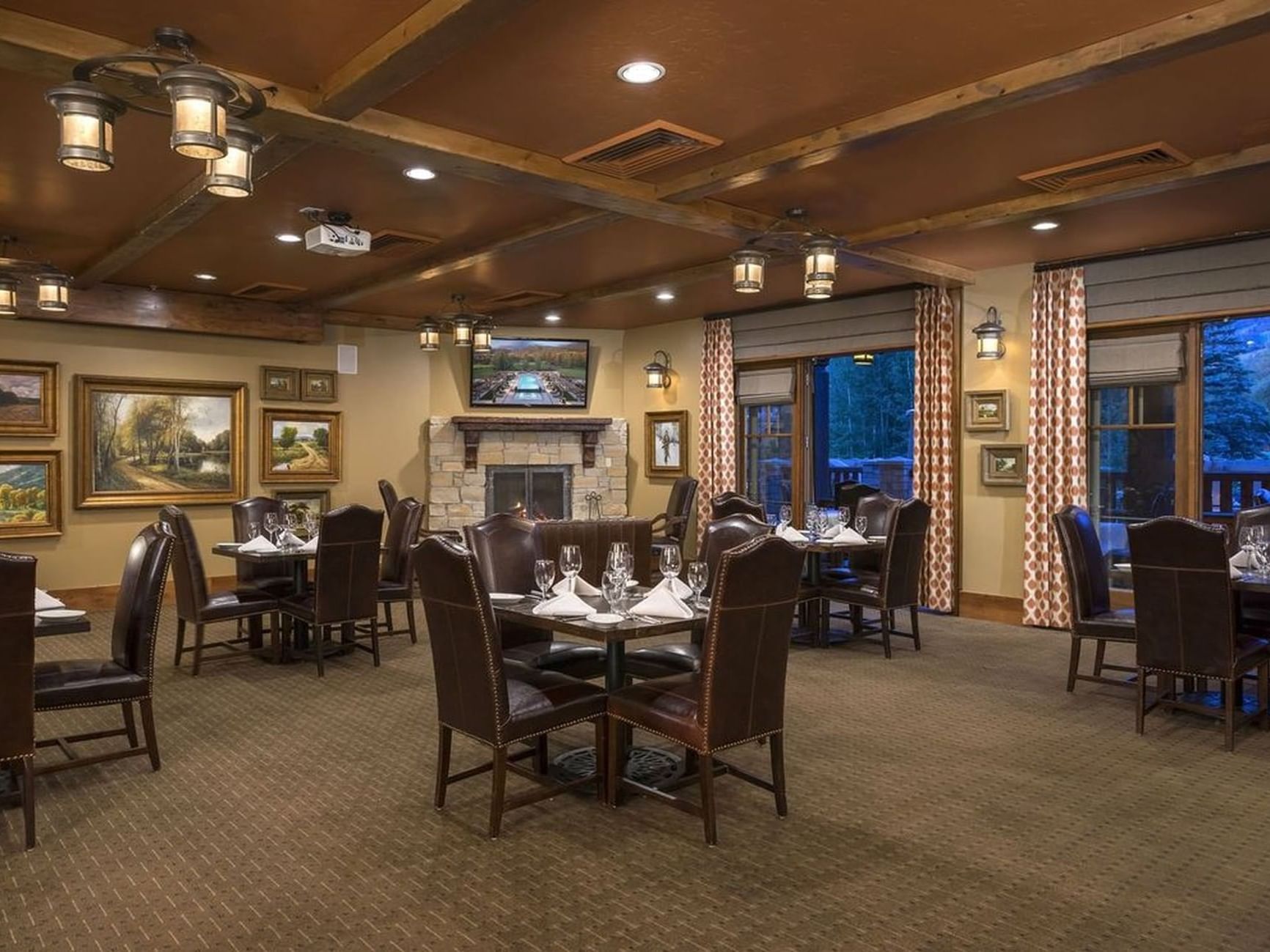 Set up banquets by the windows and wall mounted arts in the Crescent Room at Hotel Park City Autograph Collection