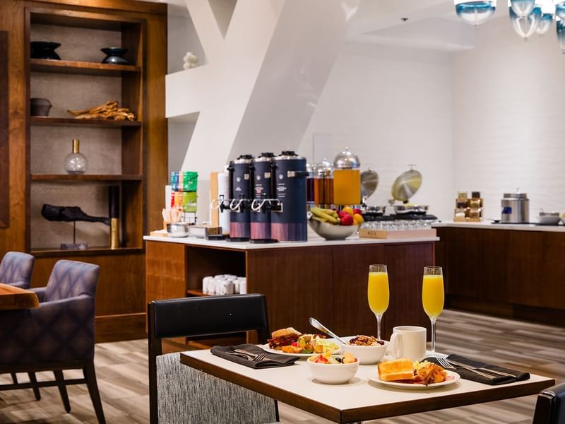 Executive Lounge with dining table, chairs, food and drinks