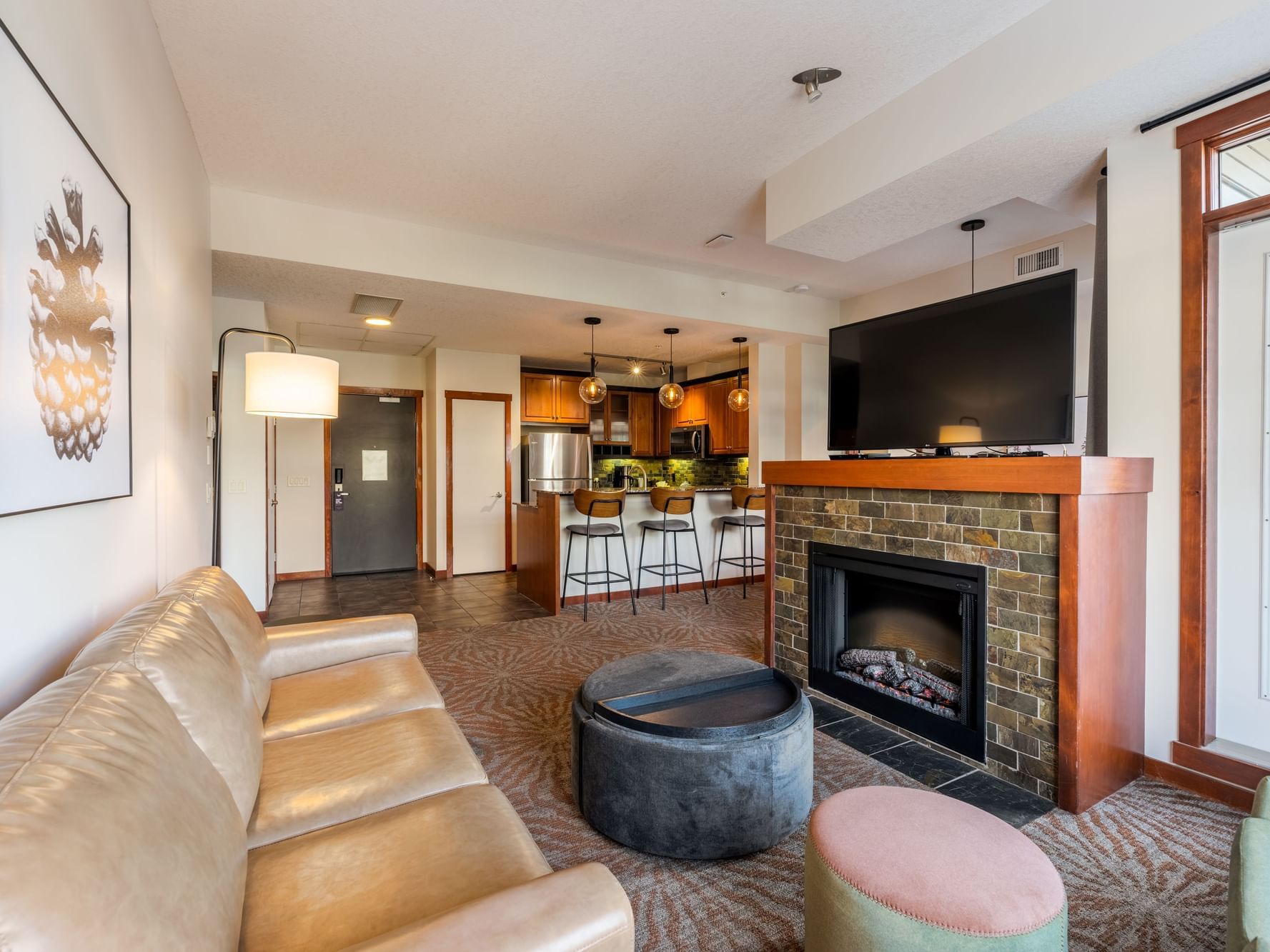 Living room with cozy loungers and fireplace in Three Bedroom Suite at Blackstone Mountain Lodge