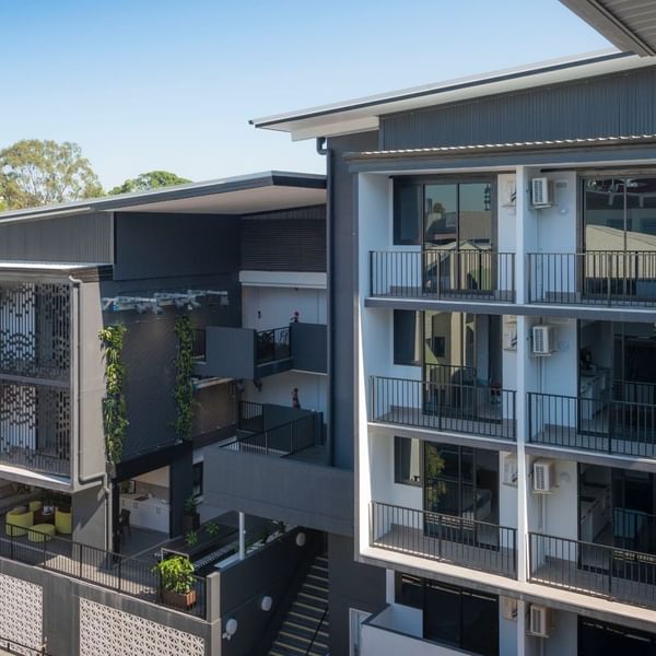 Modern multi-story student accommodation building with balconies and courtyard at UniLodge School Street Studios