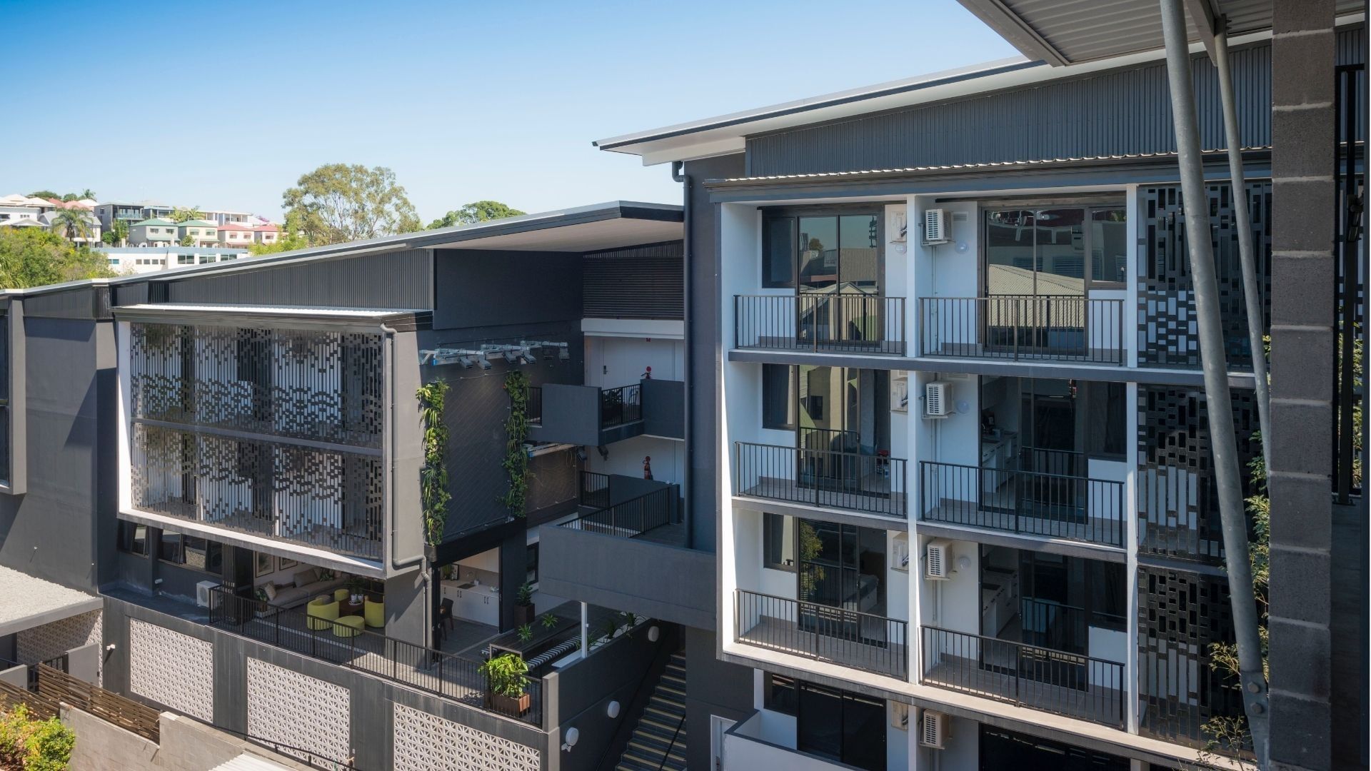 Modern multi-story student accommodation building with balconies and courtyard at UniLodge School Street Studios