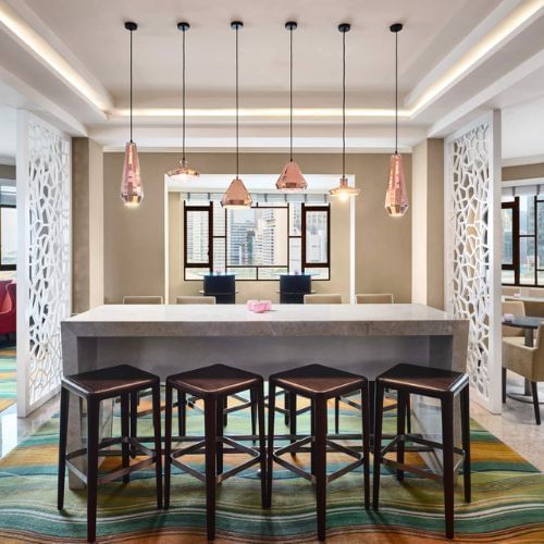 Modern kitchen with bar and stools at Paradox Singapore