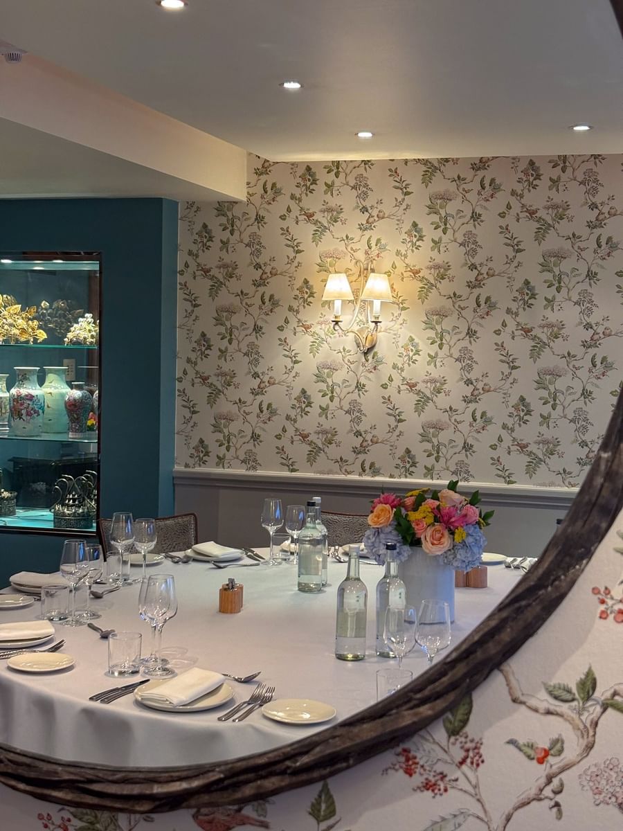 Mirror reflecting a beautifully arranged dining table in The Eaton at The Capital Hotel, Apartments and Townhouse