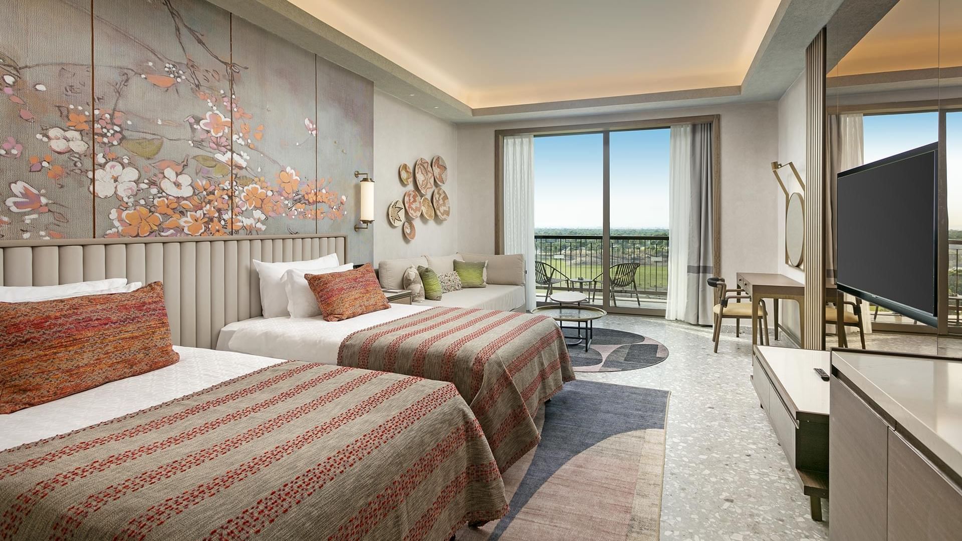 TV, seating area & work desk by the beds in Superior Room Sea View at Cullinan Belek