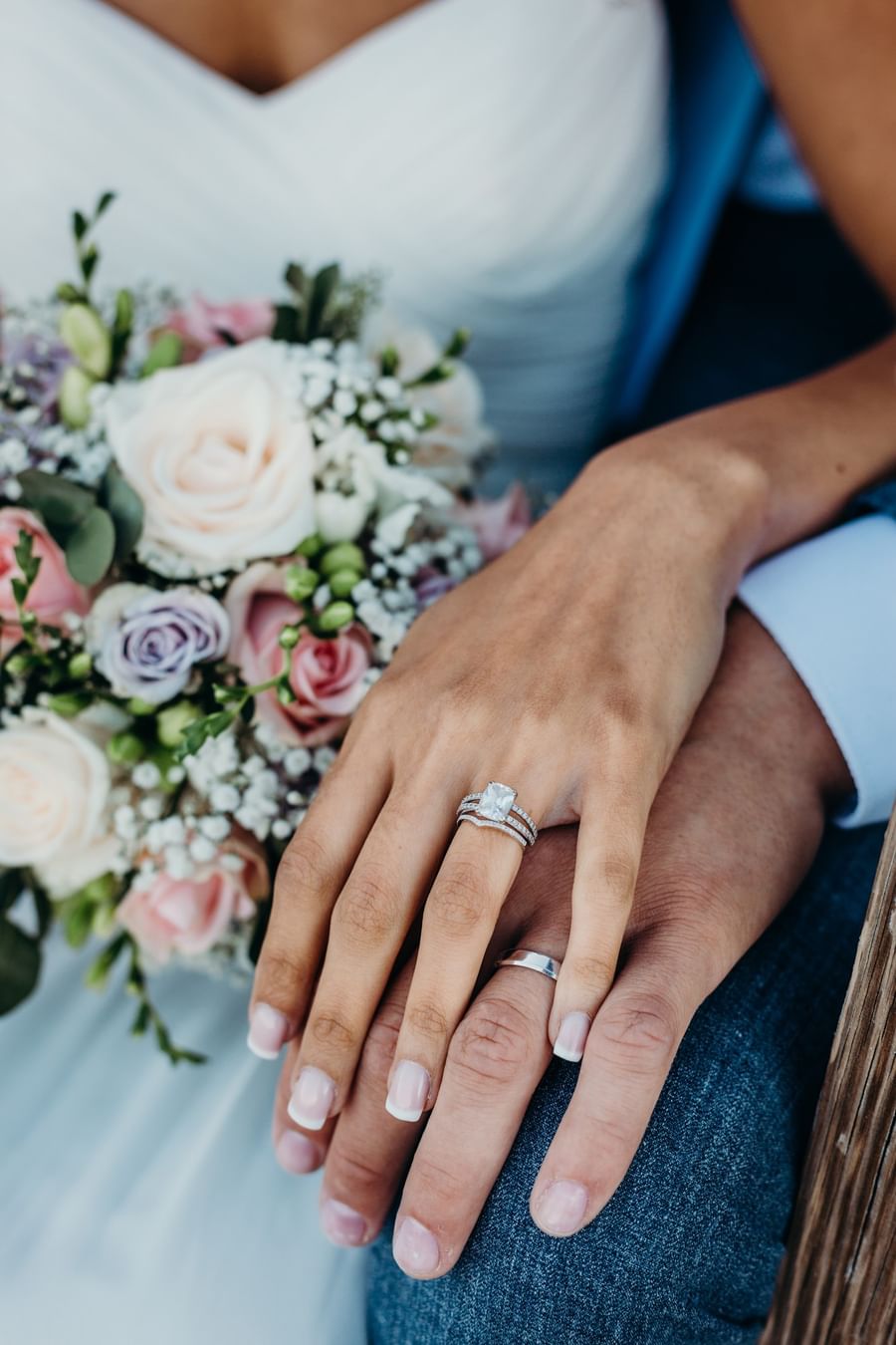 Bride and groom's hands clasped together, showing rings at Warwick Denver