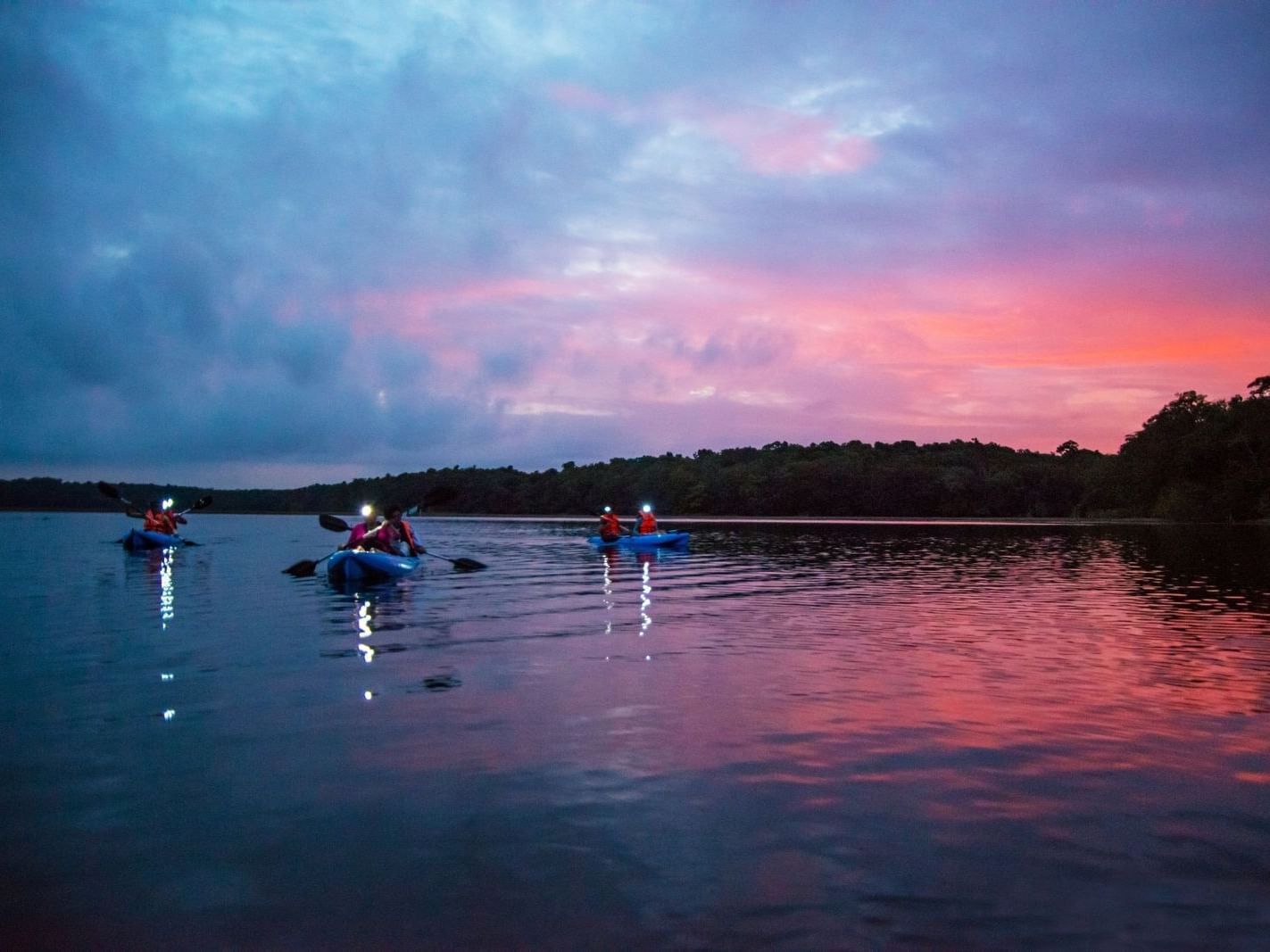 Kayaking on a lake during the sunset near La Colección Resorts