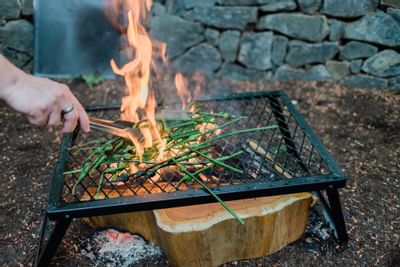 A person grilling vegetables at Alderbrook Resort & Spa