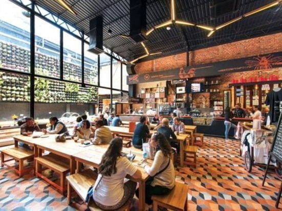 People dining in Mercado Roma near Casa Mali by Dominion